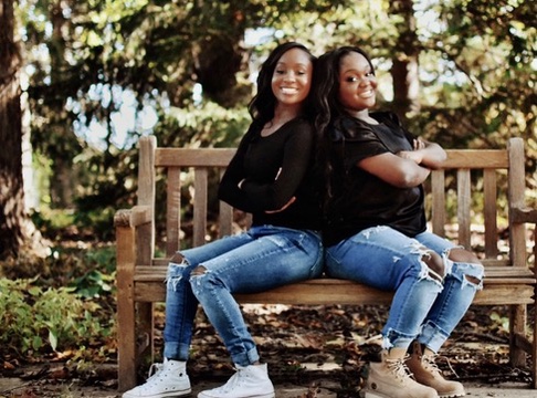 Twin girls on a park bench