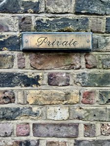 Private sign on multi-colored brick wall