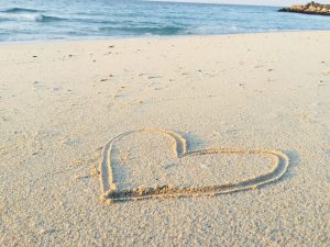 hand drawn heart in beach sand